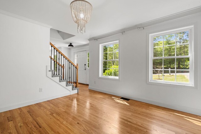 250 Harmony Rd, Northwood, NH 03261 - foyer entrance featuring stairs, a chandelier, baseboards, wood finished floors, and crown molding