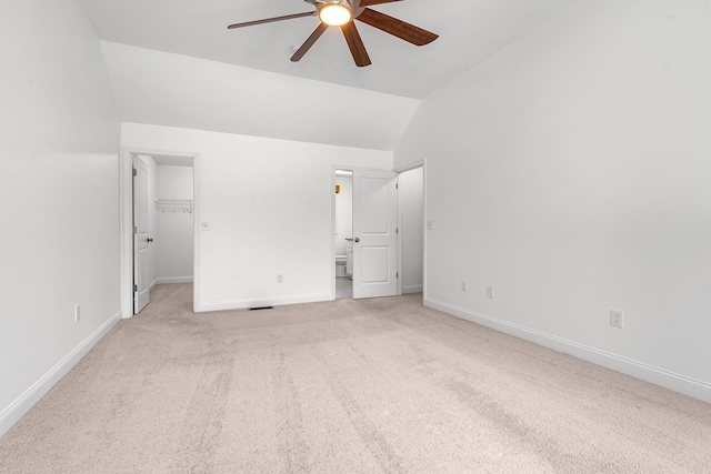 250 Harmony Rd, Northwood, NH 03261 - unfurnished bedroom featuring light carpet, lofted ceiling, a spacious closet, baseboards, and connected bathroom