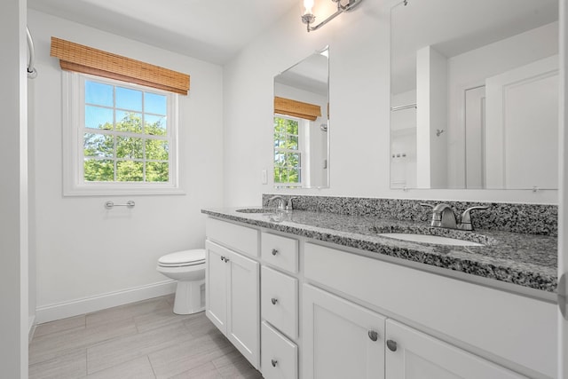 250 Harmony Rd, Northwood, NH 03261 - full bath with double vanity, baseboards, and toilet