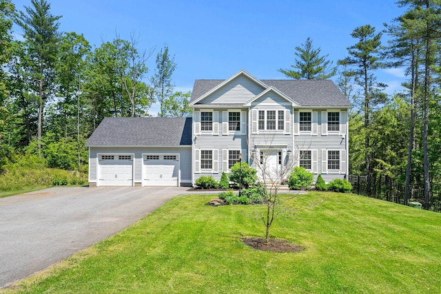 250 Harmony Rd, Northwood, NH 03261 - colonial-style house with a garage, driveway, a front yard, and a shingled roof