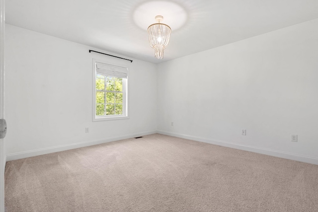 250 Harmony Rd, Northwood, NH 03261 - unfurnished room featuring light colored carpet, a chandelier, and baseboards