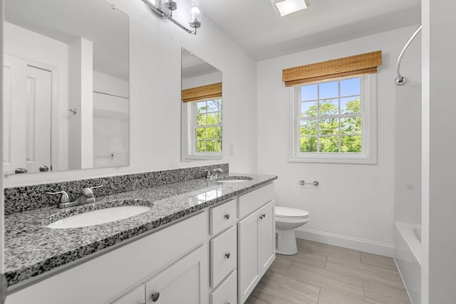 250 Harmony Rd, Northwood, NH 03261 - full bath featuring double vanity, baseboards, toilet, and bathtub / shower combination