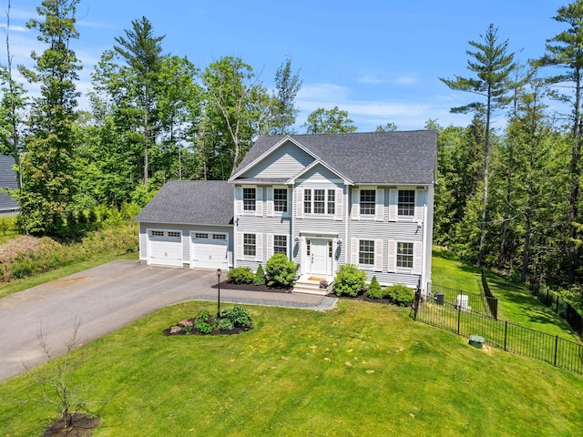 250 Harmony Rd, Northwood, NH 03261 - colonial house with asphalt driveway, an attached garage, and roof with shingles