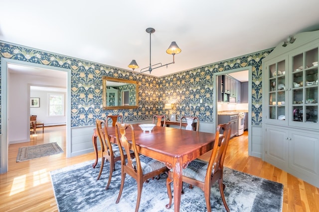 51 Carter Rd, New London, NH 03257 - dining area featuring wallpapered walls, wainscoting, and light wood-style flooring
