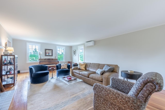 51 Carter Rd, New London, NH 03257 - living room featuring an AC wall unit, wood finished floors, and baseboards