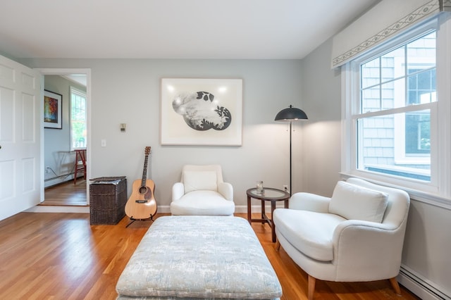 51 Carter Rd, New London, NH 03257 - sitting room featuring a baseboard radiator, plenty of natural light, and light wood-style flooring