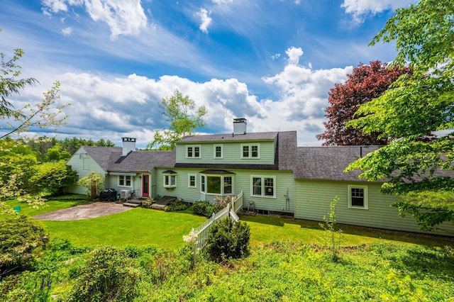 51 Carter Rd, New London, NH 03257 - back of house with a patio area, a lawn, and a chimney