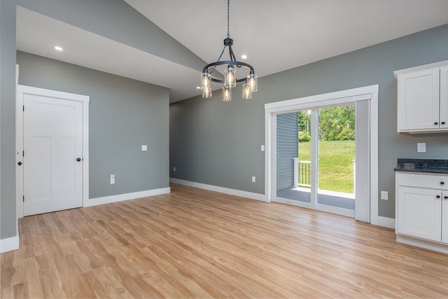 5 Midmark Ln, Concord, NH 03301 - unfurnished dining area with light wood finished floors, baseboards, vaulted ceiling, and a chandelier