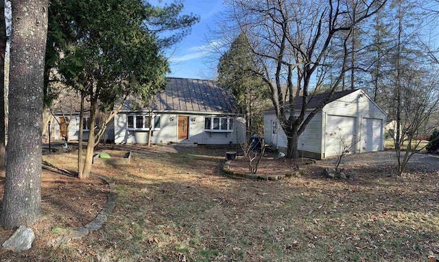 424 Main Dunstable Rd, Nashua, NH 03062 - back of house with a garage, an outbuilding, and metal roof