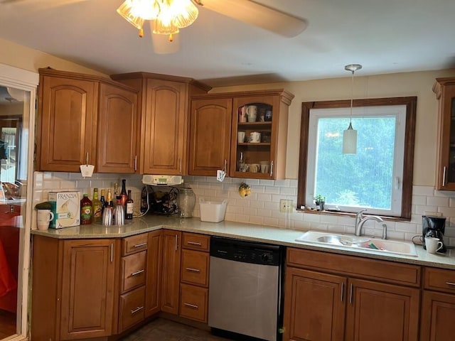 424 Main Dunstable Rd, Nashua, NH 03062 - kitchen with stainless steel dishwasher, brown cabinets, tasteful backsplash, and a sink