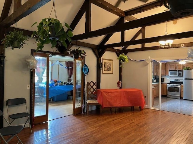 424 Main Dunstable Rd, Nashua, NH 03062 - dining room with light wood-style floors, beam ceiling, high vaulted ceiling, and a chandelier