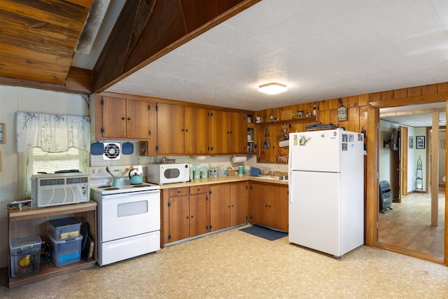 87 Lower Camp Rd, Northwood, NH 03261 - kitchen featuring white appliances, brown cabinetry, light countertops, light flooring, and a sink