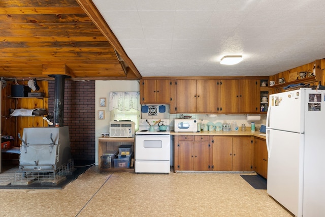 87 Lower Camp Rd, Northwood, NH 03261 - kitchen with white appliances, a wood stove, light countertops, brown cabinets, and open shelves