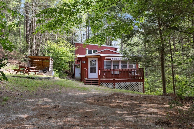 87 Lower Camp Rd, Northwood, NH 03261 - view of front of property with a wooden deck and a wooded view