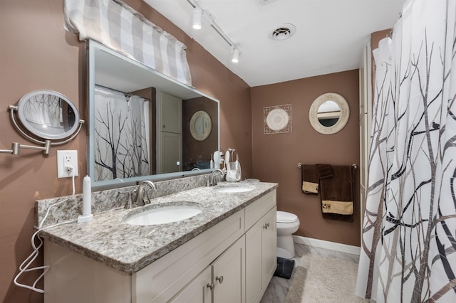 127 Shore Dr, Nashua, NH 03062 - full bathroom featuring double vanity, baseboards, toilet, and marble finish flooring