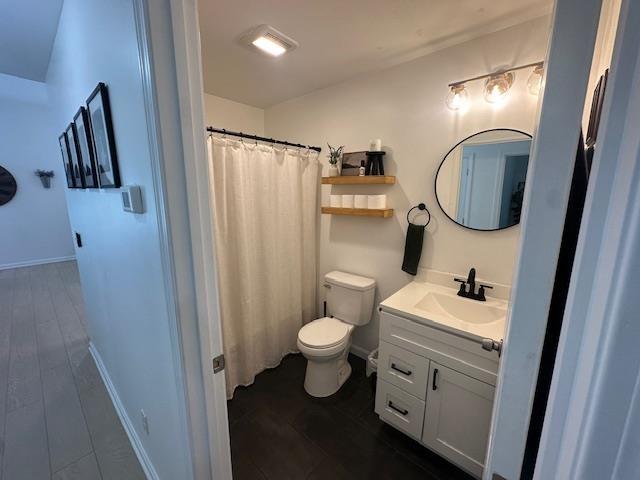 106 Betts Rd, Rochester, NH 03867 - bathroom with toilet, vanity, curtained shower, and baseboards