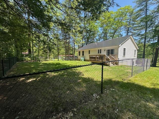106 Betts Rd, Rochester, NH 03867 - rear view of house with a deck and metal roof