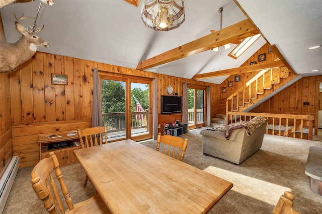 222 Main St, Alton, NH 03809 - dining room featuring a baseboard radiator, wooden walls, carpet, a chandelier, and stairway