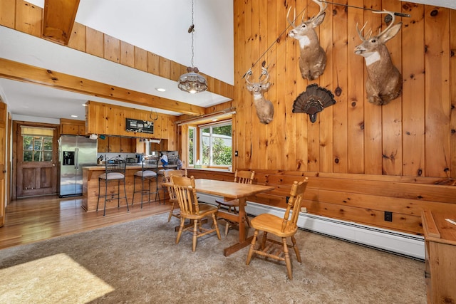 222 Main St, Alton, NH 03809 - dining space with wood walls, light wood-style flooring, a baseboard heating unit, and recessed lighting