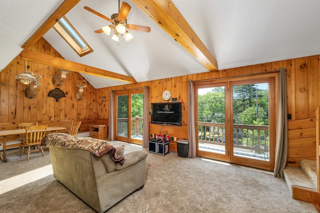 222 Main St, Alton, NH 03809 - carpeted living area with healthy amount of natural light, wooden walls, ceiling fan, and a skylight