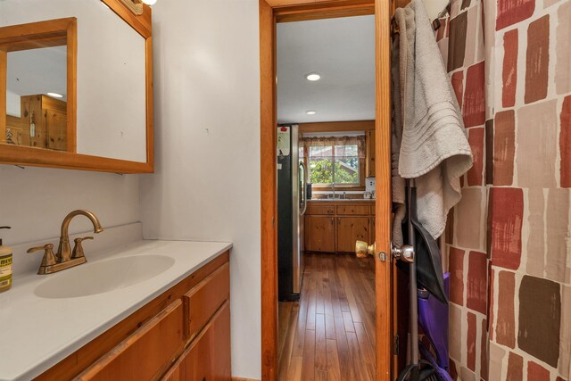 222 Main St, Alton, NH 03809 - bathroom with vanity, hardwood / wood-style floors, and recessed lighting