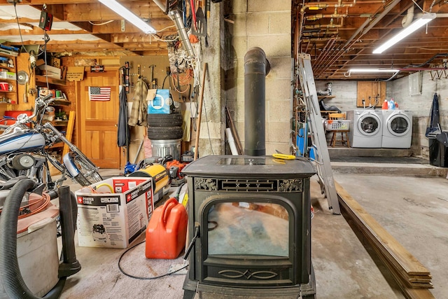222 Main St, Alton, NH 03809 - basement featuring washer and dryer and a wood stove