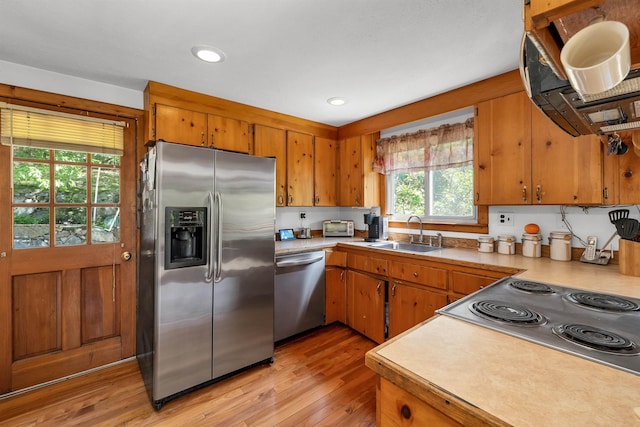222 Main St, Alton, NH 03809 - kitchen featuring stainless steel appliances, a sink, light wood-style flooring, brown cabinets, and recessed lighting