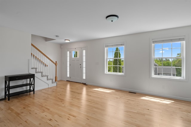 33 Thatcher Way, Barrington, NH 03825 - foyer entrance with light wood-style flooring, stairway, and baseboards