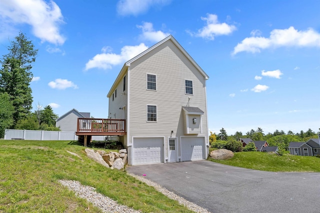 33 Thatcher Way, Barrington, NH 03825 - view of side of home with a wooden deck, an attached garage, and driveway
