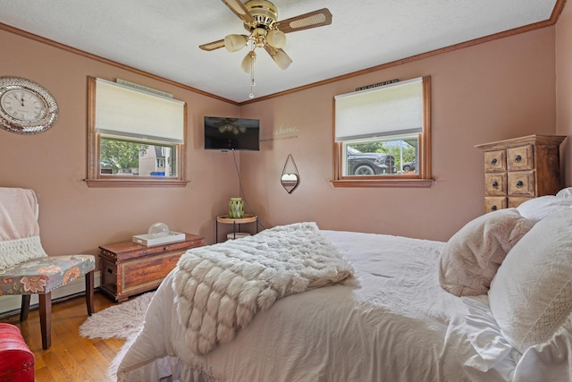 396 Huse Rd, Manchester, NH 03103 - bedroom with multiple windows, ornamental molding, wood finished floors, and a ceiling fan