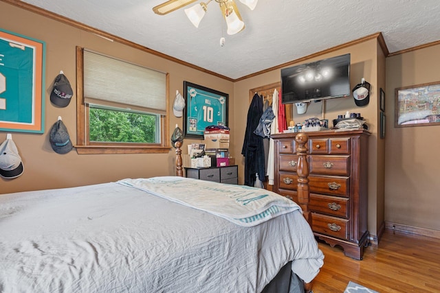 396 Huse Rd, Manchester, NH 03103 - bedroom with wood finished floors, ornamental molding, a closet, a ceiling fan, and baseboards