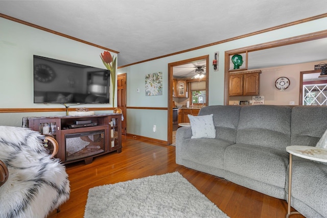396 Huse Rd, Manchester, NH 03103 - living area featuring ornamental molding, wood finished floors, plenty of natural light, baseboards, and a ceiling fan