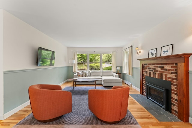 138 Connor Rd, Montpelier, VT 05602 - living area featuring wood finished floors, a brick fireplace, baseboards, and baseboard heating