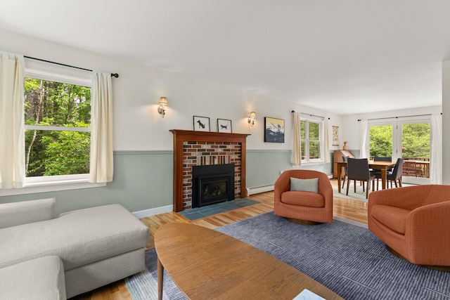138 Connor Rd, Montpelier, VT 05602 - living area with light wood-style flooring, baseboard heating, a fireplace, and baseboards