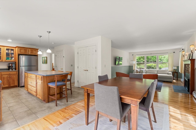 138 Connor Rd, Montpelier, VT 05602 - dining space with light wood-style flooring and a brick fireplace