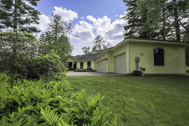 16 Carleton Way, Hales Location, NH 03860 - rear view of house with an attached garage, driveway, and a yard