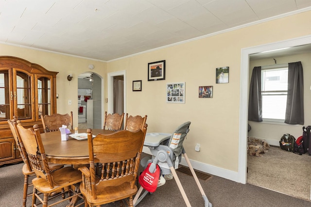 90 Sullivan St, Claremont, NH 03743 - carpeted dining space featuring ornamental molding, arched walkways, and baseboards