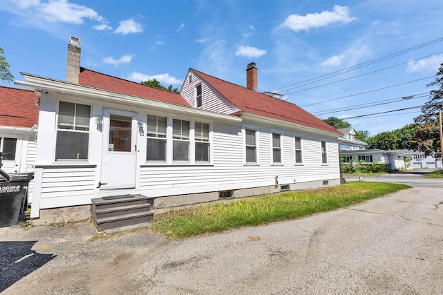 90 Sullivan St, Claremont, NH 03743 - view of front of house with entry steps, a chimney, and roof with shingles