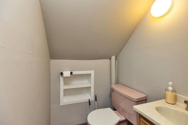 90 Sullivan St, Claremont, NH 03743 - bathroom featuring toilet, lofted ceiling, and vanity