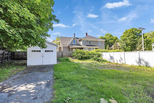 90 Sullivan St, Claremont, NH 03743 - view of yard with a garage and asphalt driveway