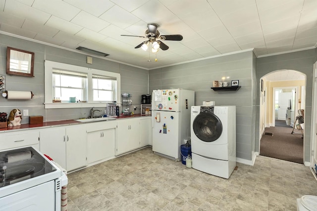 90 Sullivan St, Claremont, NH 03743 - kitchen with white appliances, washer / clothes dryer, a sink, a ceiling fan, and arched walkways