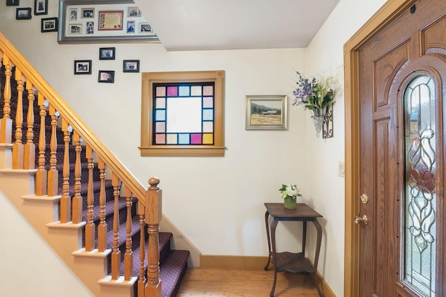 628 S Main St, Brattleboro, VT 05301 - entryway featuring wood finished floors, stairway, and baseboards