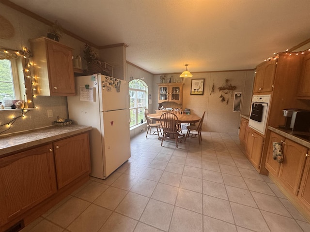 182 Franks Way, Middlesex, VT 05602 - kitchen with white appliances, crown molding, light tile patterned floors, tasteful backsplash, and brown cabinetry