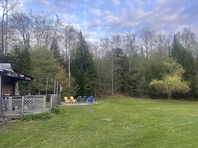 182 Franks Way, Middlesex, VT 05602 - view of grassy yard featuring a patio area, a fire pit, and a wooded view