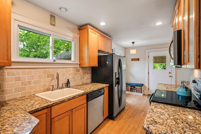 19 Abbott Rd, Concord, NH 03303 - kitchen with stainless steel appliances, a sink, backsplash, light wood-style floors, and glass insert cabinets
