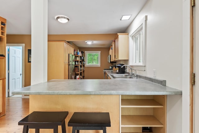 5 Adams Rd, Jackson, NH 03846 - kitchen featuring a sink, light wood-style flooring, a peninsula, light brown cabinetry, and light countertops