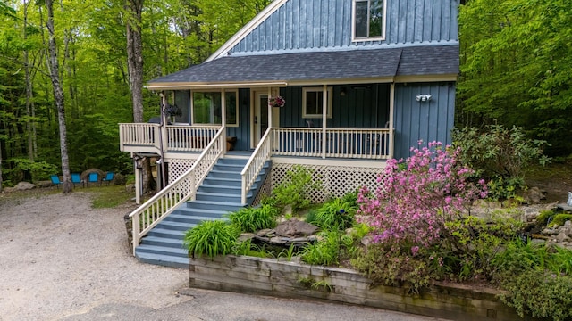 5 Adams Rd, Jackson, NH 03846 - view of front facade featuring roof with shingles, stairs, board and batten siding, and covered porch
