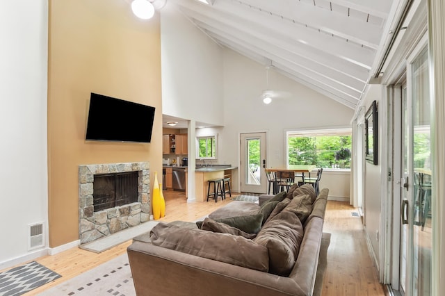 5 Adams Rd, Jackson, NH 03846 - living area featuring light wood-style floors, a stone fireplace, baseboards, high vaulted ceiling, and ceiling fan