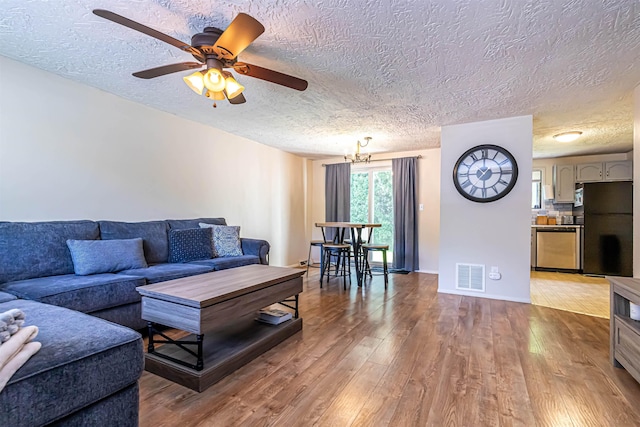 3 Cedarbrook Ave Unit C, Rochester, NH 03867 - living room with wood finished floors, a textured ceiling, a ceiling fan, and baseboards