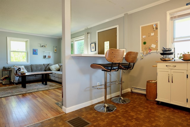 24 Abbott Rd, Concord, NH 03303 - kitchen with crown molding, a baseboard heating unit, white cabinetry, healthy amount of natural light, and baseboards
